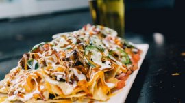 The nachos at Guy Fieri's Kitchen & Bar are big enough to share with a friend. Photo courtesy of Caesars Entertainment