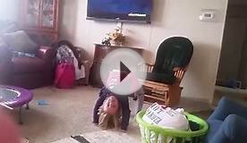 Little girl playing gymnastics at home